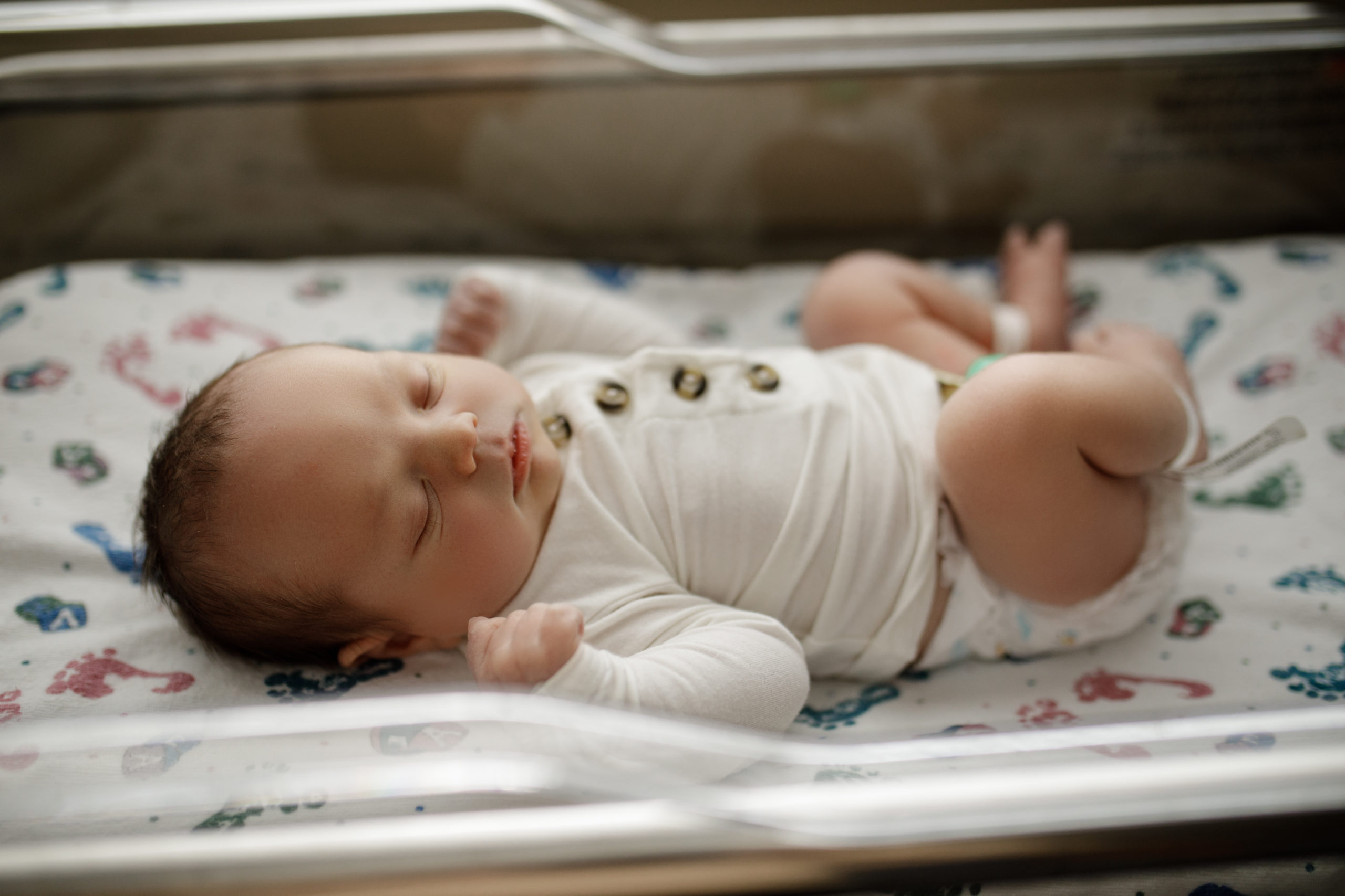 Newborn baby in hospital bassinet